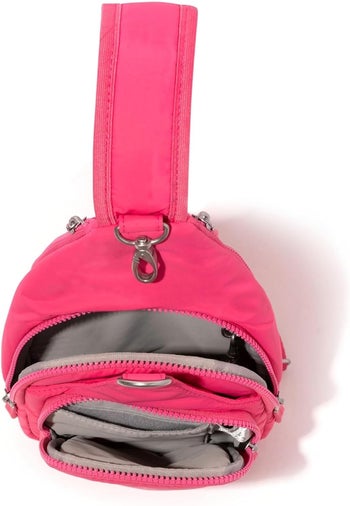 Pink version of the bag open to show the compartments inside 
