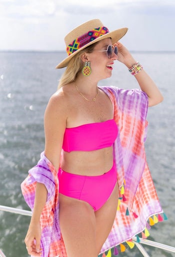 a reviewer wearing the pink set with a matching shaw and straw hat