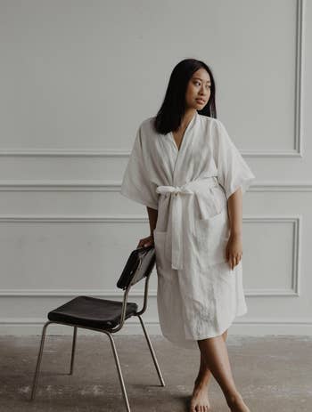 Image of model wearing white bathrobe