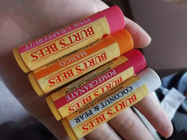  Pink Grapefruit, Mango, Pomegranate, and Coconut & Pear, held successful  a person's hand