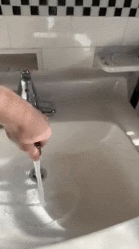 gif of reviewer moving the swivel faucet extender around their sink and changing the water pressure settings