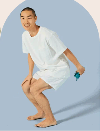 Model demonstrating how to angle the spray on their bottom 