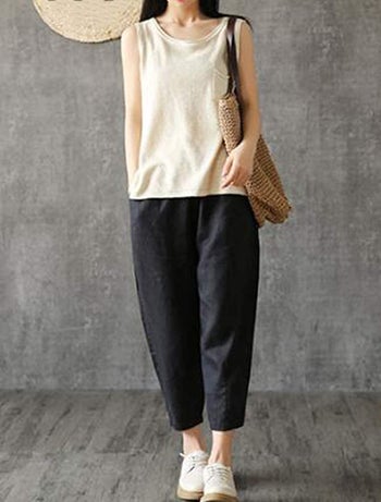 model wearing black linen tapered trousers