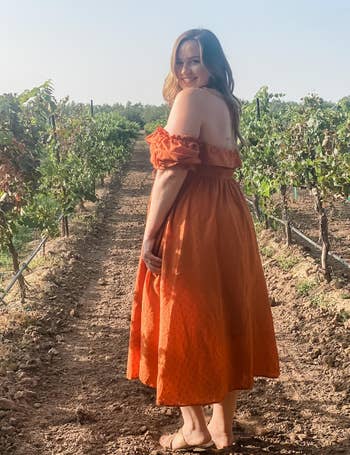 different reviewer showing the back of the dress in orange 