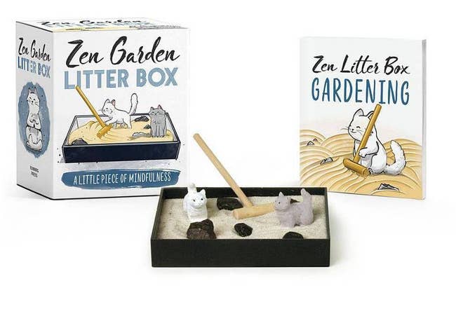 miniature zen garden with rake, two cats, sand, and rocks