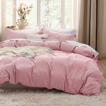 Pink duvet set on bed