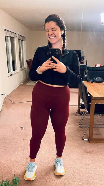 reviewer wearing the red leggings