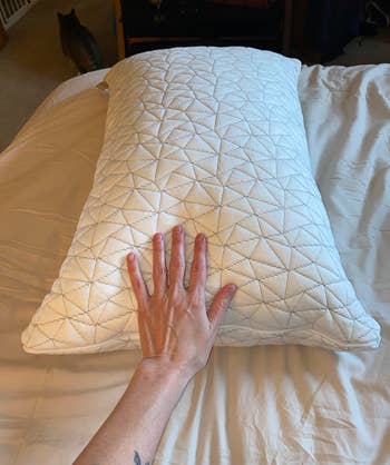 another reviewer's hand on the pillow