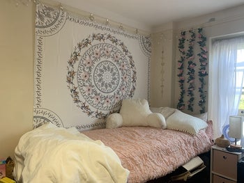 Reviewer pic of the tapestry above their dorm bed