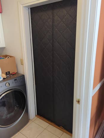 black insulated door curtain over a reviewer's laundry room door