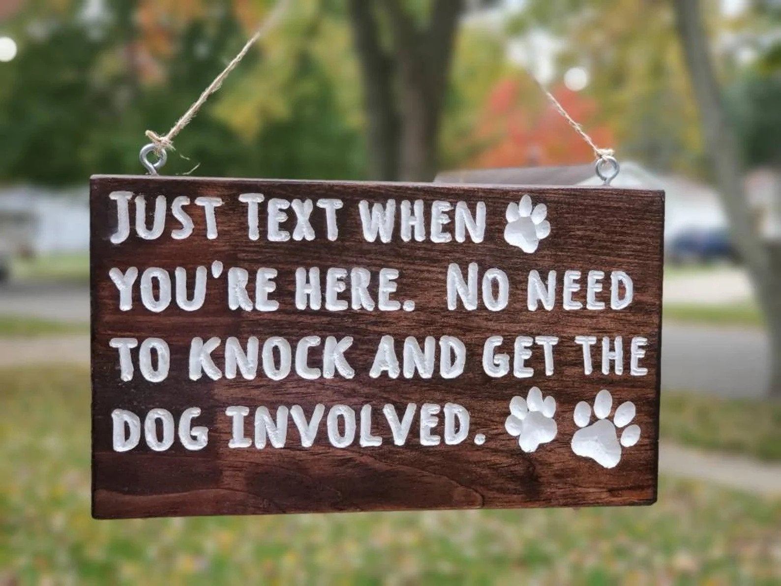 Wooden sign that says Just Text When You're Here. No Need To Knock And Get The Dog Involved.