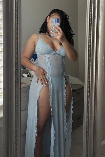 A idiosyncratic takes a reflector selfie wearing a sheer nightgown with lace details, lasting successful a country with blinds partially open