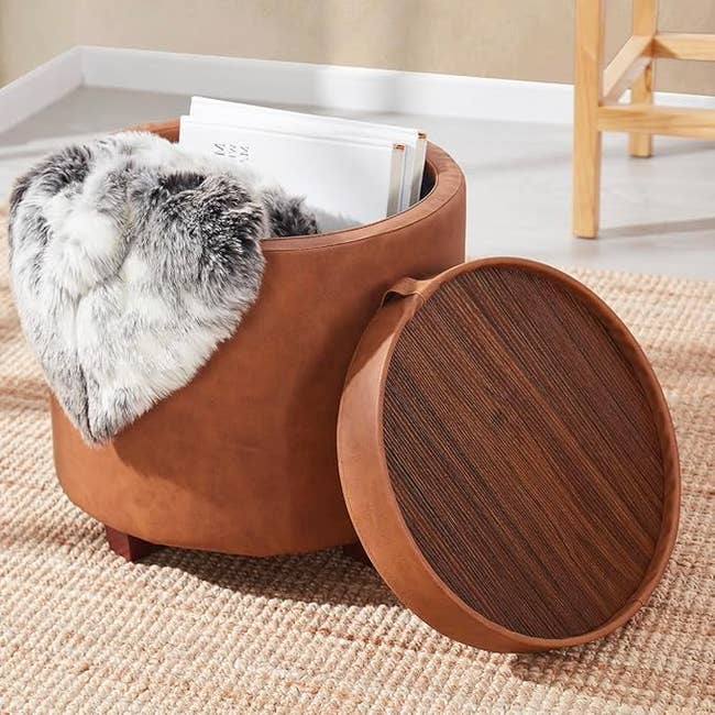 round retention  ottoman  with items wrong  and lid removed to amusement   woody  broadside  