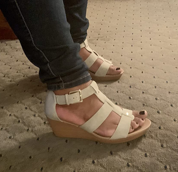 Reviewer wearing off white sandals