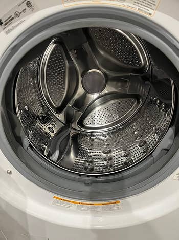 The inside of a reviewer's clean and shiny washing machine after using the tablets