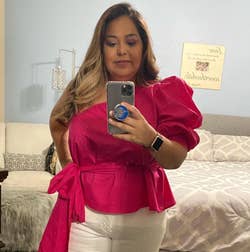 another reviewer wearing the pink belted top