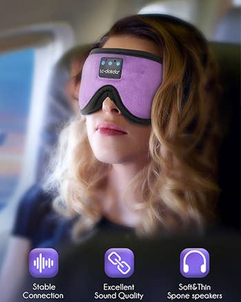 Model in purple mask on a plane