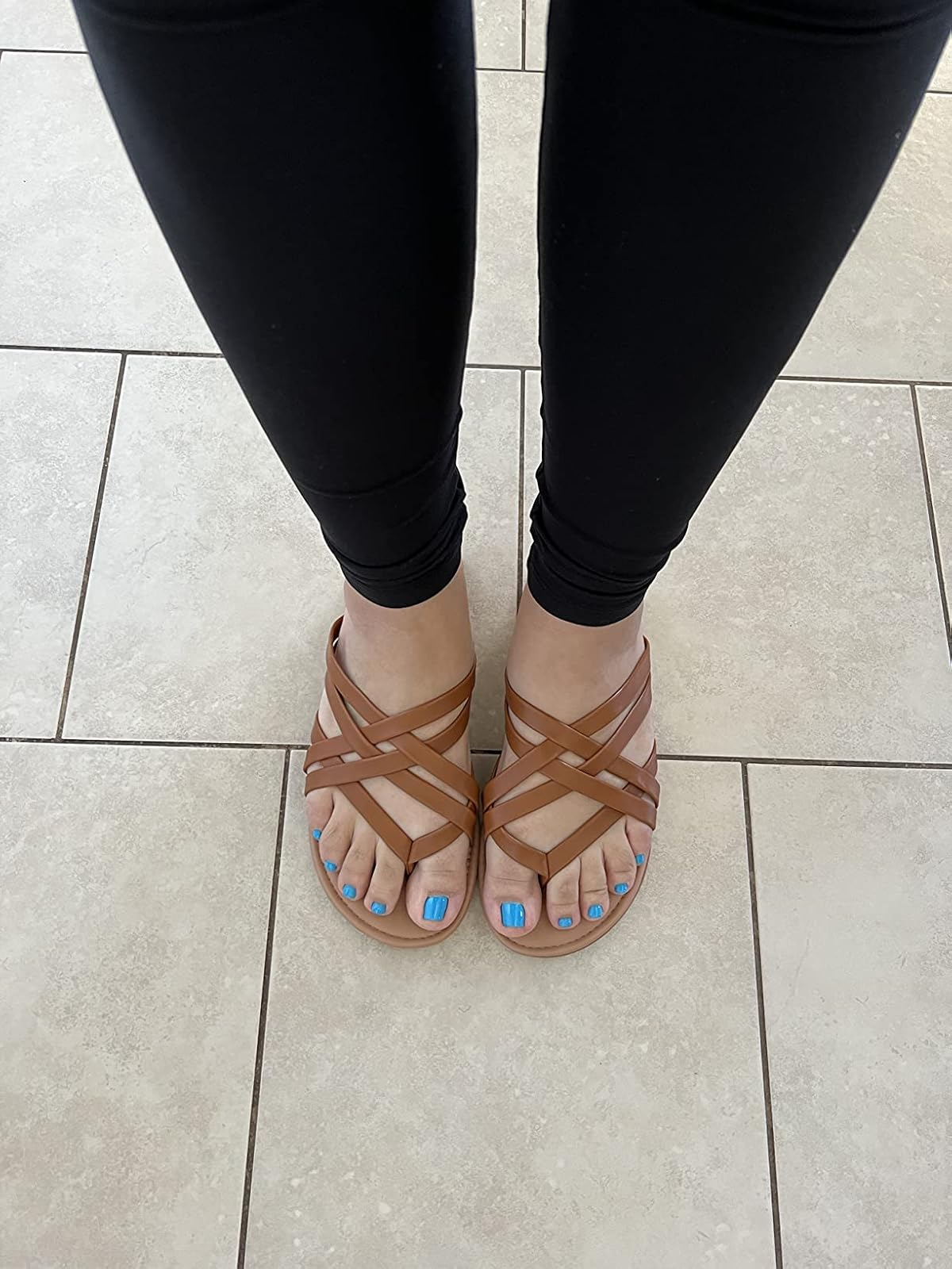 reviewer wearing the brownish  sandals