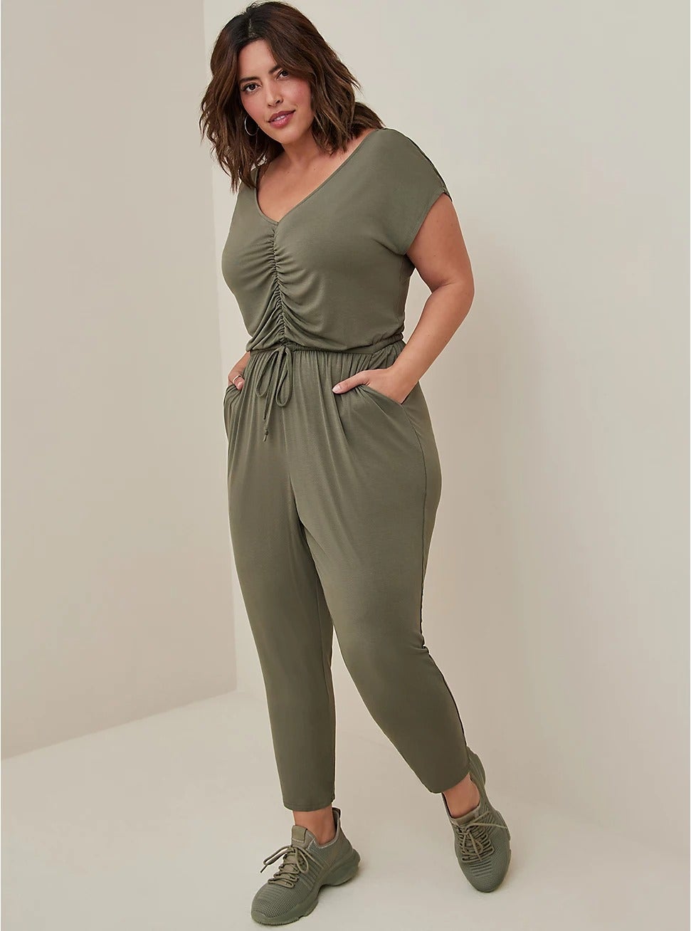 a model wearing the olive green jumpsuit