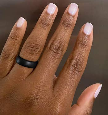 A close-up photo of a hand with neatly manicured nails