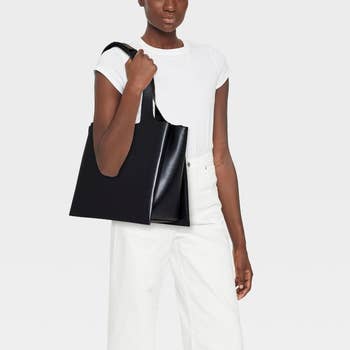 The slightly shiny black bag on a model's shoulder