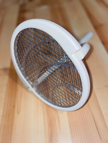 Fly swatter angled to show the rotating angled head 
