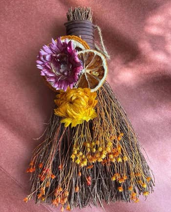 One dressed broom connected  a pinkish  background