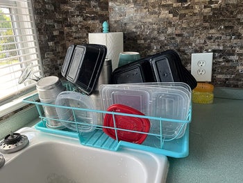 same reviewer photo of the dish rack, full of washed dishes and Tupperware