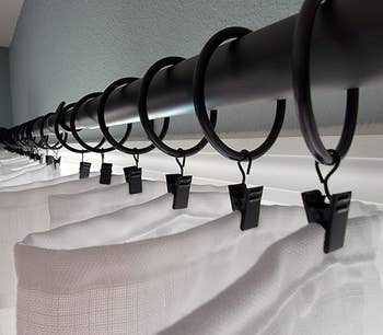 a reviewer's white curtains hung from black curtain rings