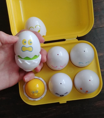 reviewer image of the carton while holding one egg toy