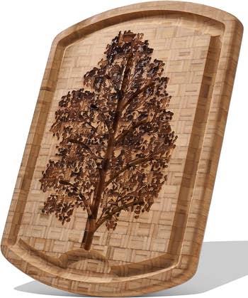 a wooden board with an etched tree motif 