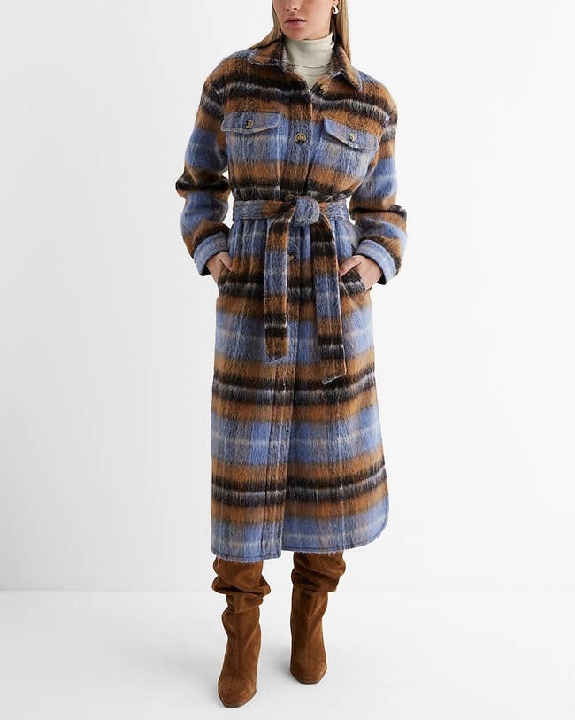 model in long fuzzy blue and brown plaid coat