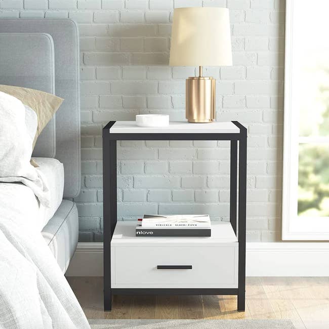 lifestyle photo of black and white nightstand in a bedroom 