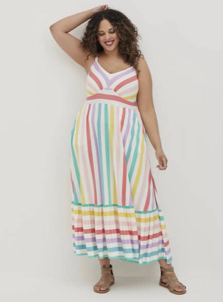 model in white sleeveless dress with bright rainbow stripes