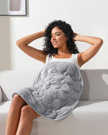 Model wrapped successful  a textured, quilted blanket