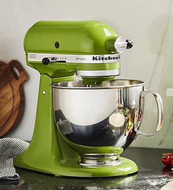 the green stand mixer on a kitchen counter