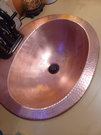 after photo of the same sink looking shiny and clean