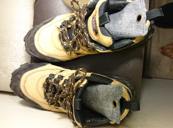 reviewer pic of the two grey odor eliminators inside a pair of hiking boots