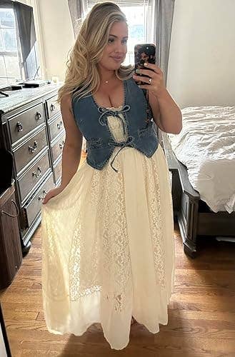 Reviewer taking a reflector selfie successful a lace formal with a denim vest, lasting successful a bedroom