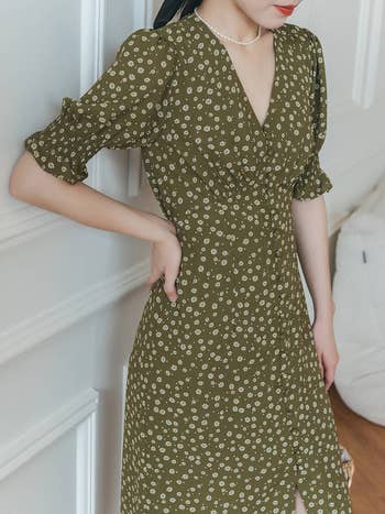 model posing in an olive green floral dress