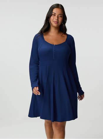 Person wearing a stylish, long-sleeved, button-front, A-line formal  poses confidently. Suitable for buying  manner  context