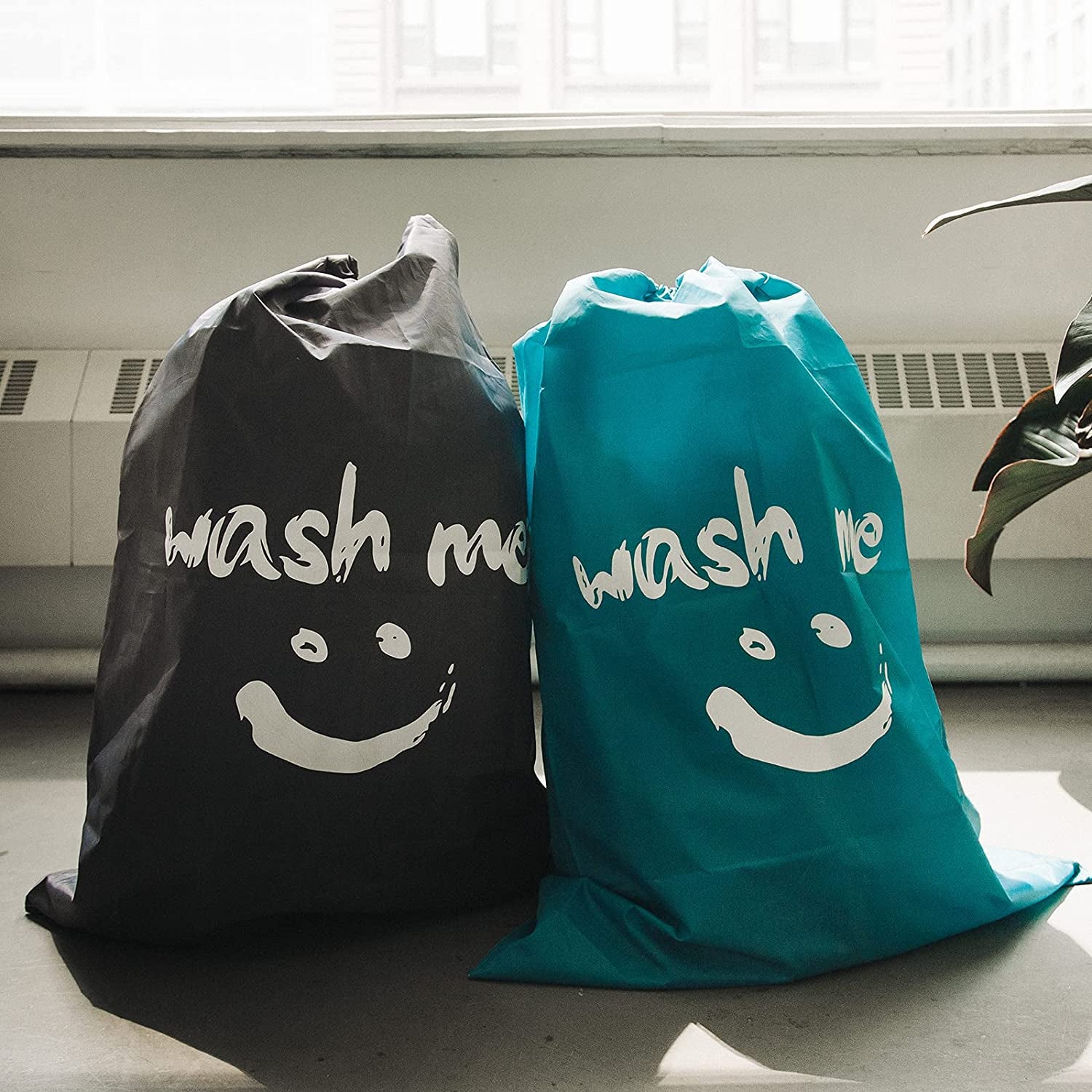 photo of full black and aqua travel laundry bags