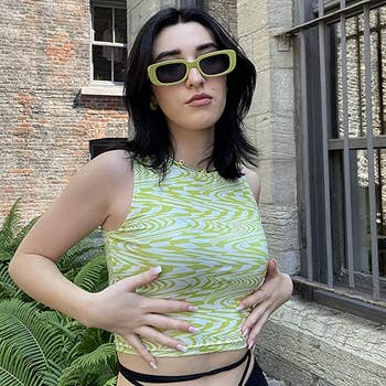 a model wearing the glasses in green