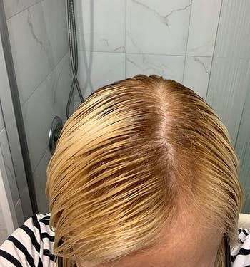 same reviewer's after photo showing their roots blending in with their blonde hair much more after using the root touch-up