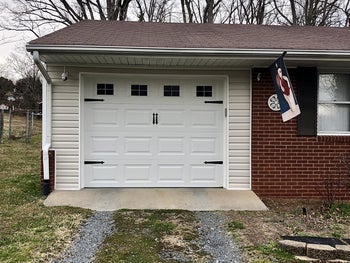 The same garage door with window decals and black handles