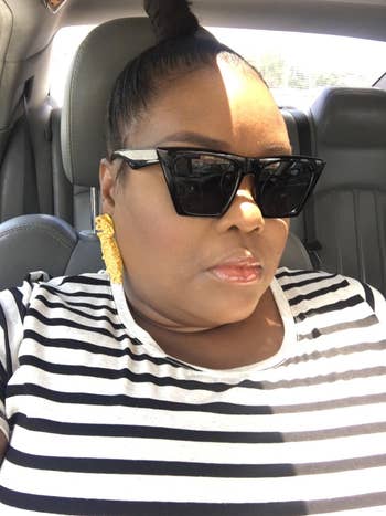 reviewer poses in the black sunglasses