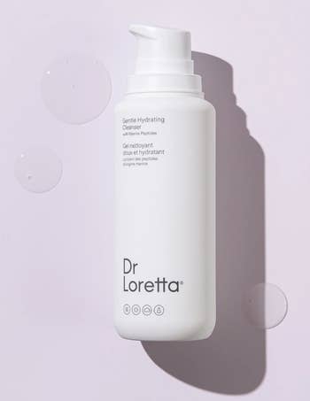 a bottle of the cleanser on a lavender background