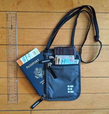 reviewer photo of neck pouch passport holder with currency and passporti nside