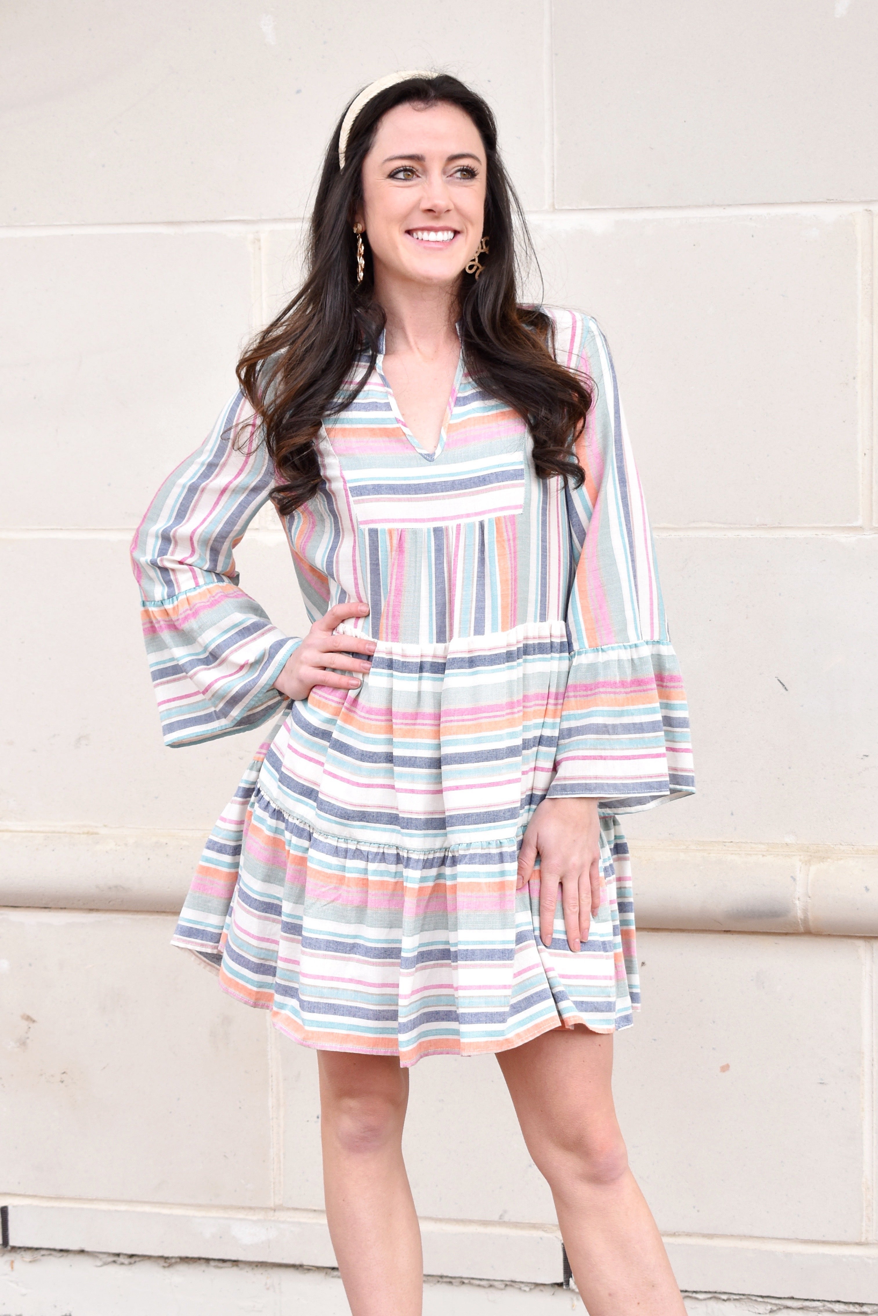 model in long sleeve colorful stripe mini dress