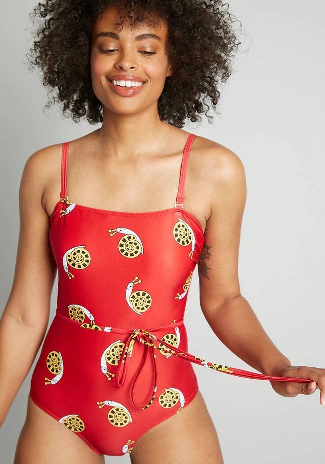 one piece suit with spaghetti straps, tie at waist, and snail pattern 